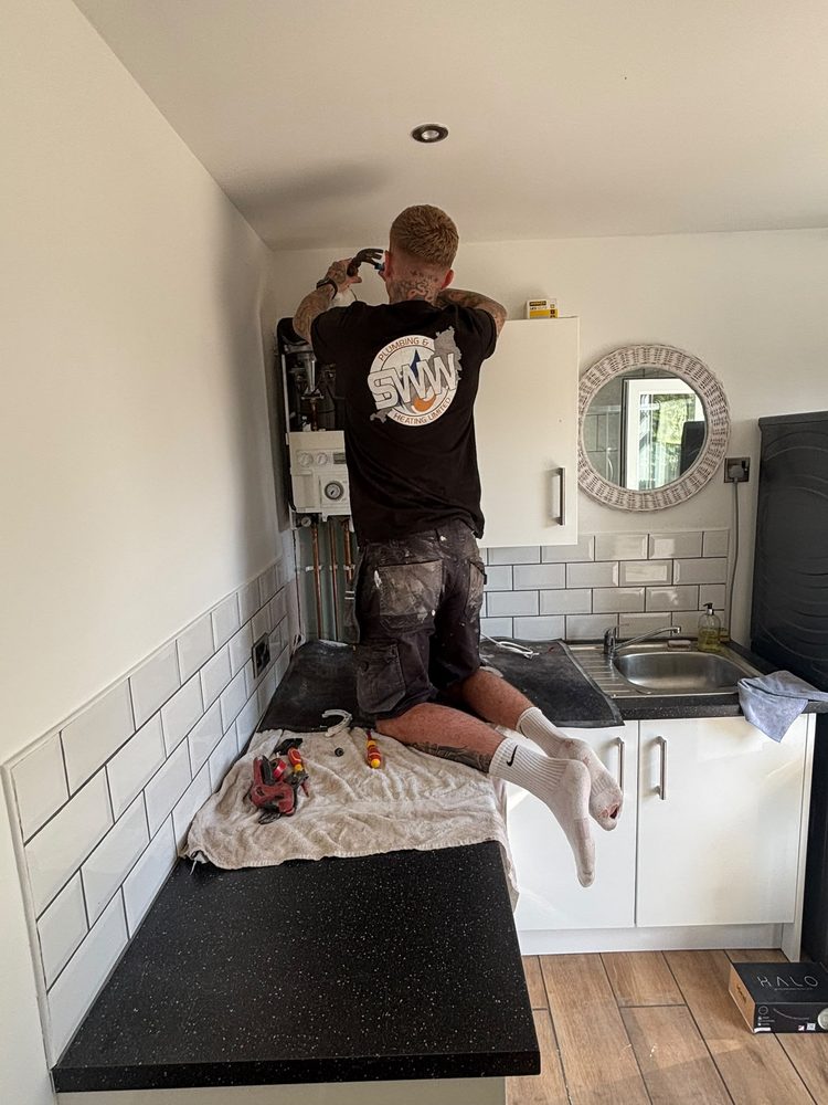 Old boiler being removed by SWW ahead of a new install in Exeter