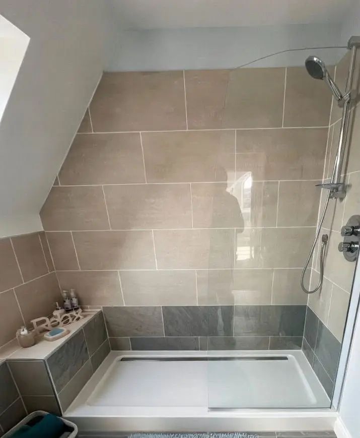 Walk-in shower with grey stone effect tiling fitted by SWW